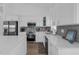 Modern kitchen features stainless appliances, quartz counters, and gray backsplash tiles at 6602 S Sherrill St, Tampa, FL 33616