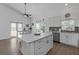 An open kitchen concept with white cabinets and a dining table at 6602 S Sherrill St, Tampa, FL 33616