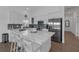 A kitchen featuring white cabinets, stainless steel appliances, and an island with seating at 6602 S Sherrill St, Tampa, FL 33616