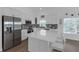 This spacious kitchen has an island with seating, stainless appliances, and bright natural light at 6602 S Sherrill St, Tampa, FL 33616
