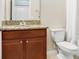 Bathroom showcasing a granite-topped vanity and a standard toilet at 6620 Paden Wheel St, Zephyrhills, FL 33541