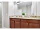 Bathroom featuring a granite-topped vanity with double sinks and ample cabinet space at 6620 Paden Wheel St, Zephyrhills, FL 33541