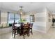 Inviting dining room with a wooden table, bench seating and stylish light fixture at 6620 Paden Wheel St, Zephyrhills, FL 33541