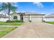 Charming single-story home featuring a well-manicured lawn and a spacious two-car garage at 6620 Paden Wheel St, Zephyrhills, FL 33541