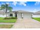 Charming single-story home featuring a well-manicured lawn and a spacious two-car garage at 6620 Paden Wheel St, Zephyrhills, FL 33541