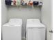 Laundry room featuring a washer, dryer and shelving for storage at 6620 Paden Wheel St, Zephyrhills, FL 33541