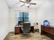 Office space featuring a desk, ceiling fan, and wood-look floors at 6620 Paden Wheel St, Zephyrhills, FL 33541