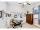 Well-lit office space with functional desk, wall art, carpeting, and storage, ideal for productivity at 6620 Paden Wheel St, Zephyrhills, FL 33541