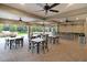 A spacious outdoor patio area with tables, chairs, and ceiling fans for comfortable gatherings at 6620 Paden Wheel St, Zephyrhills, FL 33541