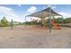 Community playground featuring slides, climbing structures, and ample space for children to play at 6620 Paden Wheel St, Zephyrhills, FL 33541