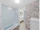 Bathroom with a walk-in shower and stylish wallpaper at 700 Starkey Rd # 311, Largo, FL 33771