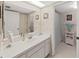 Well-lit bathroom featuring a large mirror, neutral color scheme, and a combined shower and tub at 700 Starkey Rd # 311, Largo, FL 33771