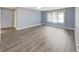 Spacious bedroom with wood flooring, window, closet, and light blue painted walls at 700 Starkey Rd # 311, Largo, FL 33771