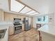 Modern kitchen with stainless appliances, wood floors, and ample countertop space at 700 Starkey Rd # 311, Largo, FL 33771