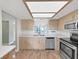 Bright kitchen with stainless steel appliances and a view of the water at 700 Starkey Rd # 311, Largo, FL 33771