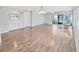 Open concept living room with wood floors, bar area, and access to a screened lanai at 700 Starkey Rd # 311, Largo, FL 33771
