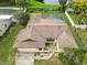 A bird's-eye view reveals the home's roof, yard, and surrounding landscape at 7018 Arbor View Ln, New Port Richey, FL 34653