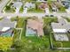 A neighborhood view from above, showcasing homes, pools, lawns, and surrounding streets at 7018 Arbor View Ln, New Port Richey, FL 34653
