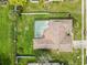 An aerial shot showing the home's layout with a pool, lawn, and privacy fence at 7018 Arbor View Ln, New Port Richey, FL 34653