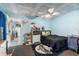 This is a bedroom with blue walls, a bed set and colorful decorations throughout at 7018 Arbor View Ln, New Port Richey, FL 34653