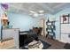 View of a bedroom with light blue walls and a ceiling fan, including a work space and a black bed set at 7018 Arbor View Ln, New Port Richey, FL 34653