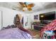 Bedroom features a ceiling fan and a large television at 7018 Arbor View Ln, New Port Richey, FL 34653