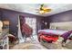 Bedroom with a ceiling fan and a sliding glass door to the outside at 7018 Arbor View Ln, New Port Richey, FL 34653