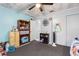 View of a bedroom with carpet flooring, a ceiling fan, closet, and colorful decorations and furniture at 7018 Arbor View Ln, New Port Richey, FL 34653