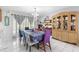 Bright dining room with a chandelier and sliding glass doors to the backyard at 7018 Arbor View Ln, New Port Richey, FL 34653