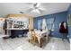 Open concept dining room with access to the kitchen; featuring tile floors, floral tablecloth, and blue accent wall at 7018 Arbor View Ln, New Port Richey, FL 34653
