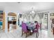 Dining room with an archway to the kitchen and a view of the pool at 7018 Arbor View Ln, New Port Richey, FL 34653