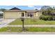Single-Gathering home featuring an attached one-car garage and a traditional mailbox at 7018 Arbor View Ln, New Port Richey, FL 34653