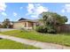 Single-Gathering home with a one-car garage and mature landscaping in the front yard at 7018 Arbor View Ln, New Port Richey, FL 34653