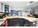 Kitchen with tile flooring and a breakfast bar area, open to the dining area at 7018 Arbor View Ln, New Port Richey, FL 34653