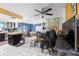 Open living area with tile flooring, ceiling fans, and a view into the dining room and kitchen at 7018 Arbor View Ln, New Port Richey, FL 34653