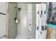 Walk-in shower with gray tiling, built in shower caddy and black shower head at 7018 Arbor View Ln, New Port Richey, FL 34653