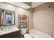 Bathroom with neutral tile, dark vanity and a view to the rest of the home at 852 Crystal Dr, Palm Harbor, FL 34683