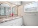 Bathroom featuring double vanity with granite counters, framed mirrors, and tiled walk-in shower at 852 Crystal Dr, Palm Harbor, FL 34683