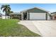 Charming home with a two-car garage, well-maintained lawn, and lush landscaping at 852 Crystal Dr, Palm Harbor, FL 34683