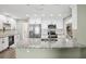 Bright kitchen featuring white cabinets, stainless steel appliances, and granite countertops at 852 Crystal Dr, Palm Harbor, FL 34683