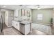 Modern kitchen with white cabinets, stainless steel appliances, and spacious countertop island at 852 Crystal Dr, Palm Harbor, FL 34683