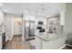 Bright kitchen featuring white cabinets, stainless steel appliances, and granite countertops at 852 Crystal Dr, Palm Harbor, FL 34683