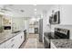 Modern kitchen featuring white cabinets, stainless steel appliances, and granite countertops at 852 Crystal Dr, Palm Harbor, FL 34683