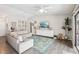 Open living room with high ceiling, gray walls, and a large comfortable couch over a stylish area rug at 852 Crystal Dr, Palm Harbor, FL 34683