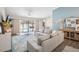 Bright living room features sliding glass doors to pool, modern decor, and an open floor plan at 852 Crystal Dr, Palm Harbor, FL 34683