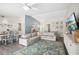Living room with a view of dining room, light blue walls, modern furniture, and stylish area rug at 852 Crystal Dr, Palm Harbor, FL 34683