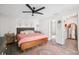 Well-lit main bedroom with modern ceiling fan, a decorative rug, and access to an en-suite bathroom at 852 Crystal Dr, Palm Harbor, FL 34683
