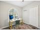 Bright office features a desk, arched window, and closet at 852 Crystal Dr, Palm Harbor, FL 34683