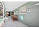 Covered patio area with painted concrete and decorative wall art at 852 Crystal Dr, Palm Harbor, FL 34683