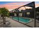 Screened in pool with lighting for evening swims at 852 Crystal Dr, Palm Harbor, FL 34683